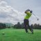 Golfer tee shot on scenic golf course